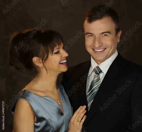 Photo: Young well-dressed smiling man and woman in evening dress Young well-dressed smiling man and woman in evening dress