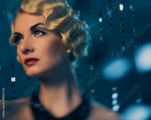 Photo: Elegant blond retro woman with beautiful hairdo and red lipstick Elegant blond retro woman with beautiful hairdo and red lipstick