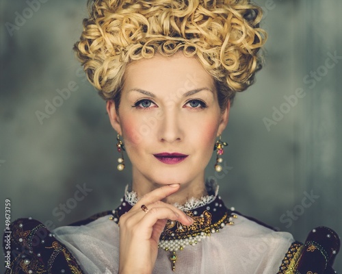 Photo: Portrait of beautiful haughty queen in royal dress Portrait of beautiful haughty queen in royal dress