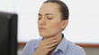 Young woman coughing in the office, close up