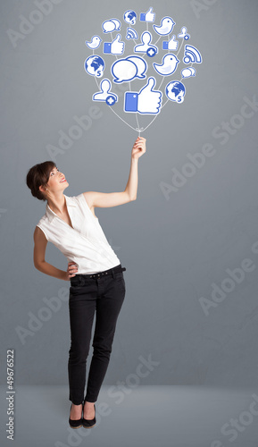 Photo: Pretty woman holding social icon balloon Pretty woman holding social icon balloon