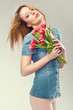 Beautiful young woman with a bouquet of flowers