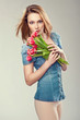 Beautiful young woman with a bouquet of flowers