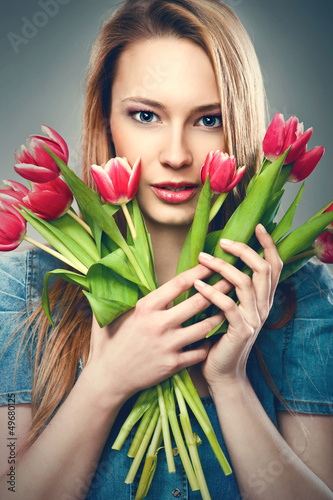 Photo: Beautiful young woman with a bouquet of flowers Beautiful young woman with a bouquet of flowers
