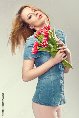 Photo: Beautiful young woman with a bouquet of flowers Beautiful young woman with a bouquet of flowers