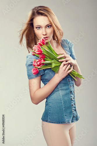 Photo: Beautiful young woman with a bouquet of flowers Beautiful young woman with a bouquet of flowers