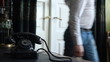 Vintage black telephone. Man dials 