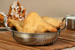 samosas in a metal dish