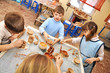 Photo: .group of children shaping clay in pottery studio .group of children shaping clay in pottery studio