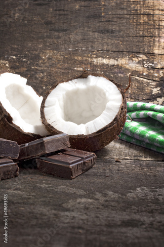 Photo: Coconut with chocolate on old wooden background Coconut with chocolate on old wooden background