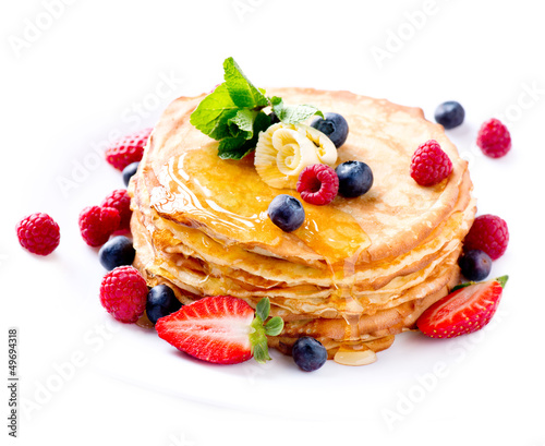 Photo: Pancake. Crepes With Berries. Pancakes stack isolated on White Pancake. Crepes With Berries. Pancakes stack isolated on White