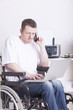 young man in wheelchair using a laptop