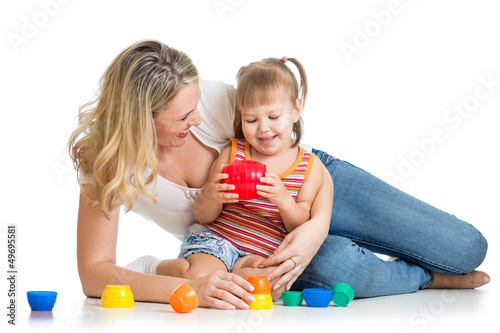 Photo: kid girl and mother playing together with cup toys kid girl and mother playing together with cup toys