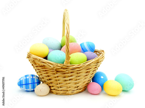 Photo: Easter basket with colorful eggs over white Easter basket with colorful eggs over white