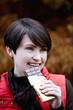 A woman eating a bar of chocolate