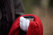 A woman holding a hot drink in autumn time, close up