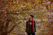 A woman walking through the countryside in autumn time