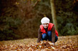 A woman gathering autumn leaves