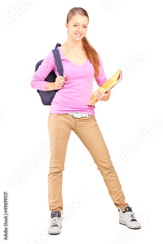 Photo: Full length portrait of a female student holding backpac Full length portrait of a female student holding backpac