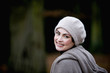 A portrait of a woman wearing a woollen hat in autumn time