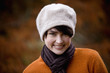 A portrait of a woman wearing a woollen hat in autumn time
