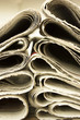 closeup pile of newspaper on wooden background