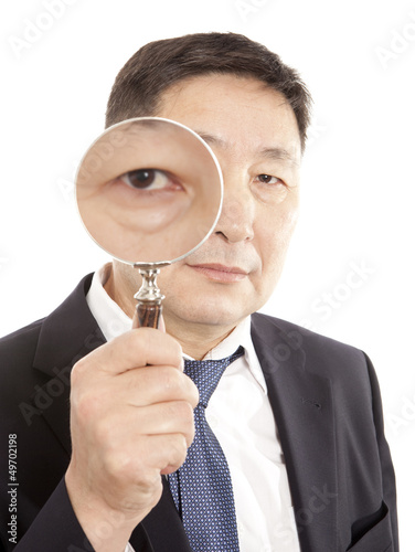 Photo: Businessman looking a magnifying glass Businessman looking a magnifying glass