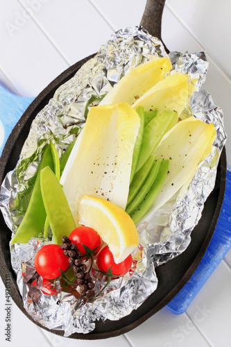 Photo: Fresh vegetables on tinfoil in skillet Fresh vegetables on tinfoil in skillet