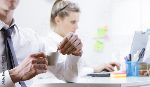 Photo: Young business man taking coffee break Young business man taking coffee break