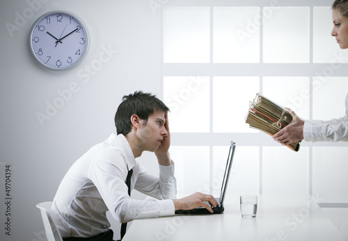 Photo: overworked businessman overworked businessman