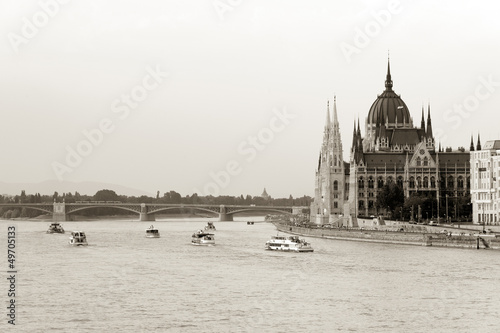 Photo: Boats cruising by Parliament building in Budapest Boats cruising by Parliament building in Budapest
