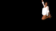 Girl in white dress jumping on black background with copy space