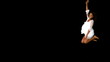Girl in white jumping on black background with large copy space
