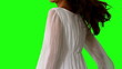 Girl in white dress twirling on green screen close up