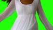 Girl in white dress turning on green screen close up