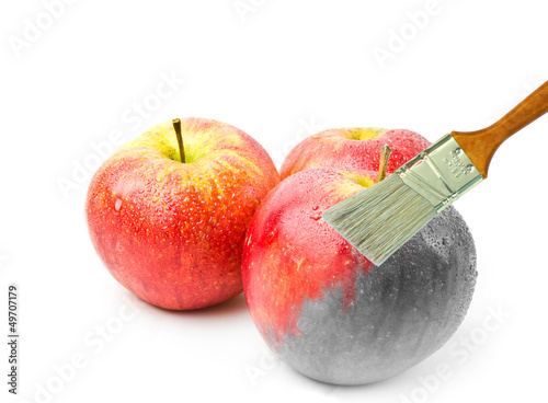 Photo: paintbrush painting a fresh red wet apple paintbrush painting a fresh red wet apple