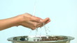 Woman washing her hands under stream of water in a sink
