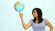 Smiling woman spinning globe on finger
