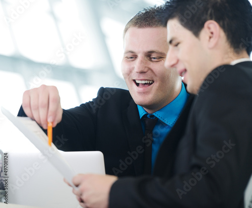 Photo: Several employees discussing new ideas in groups at meeting Several employees discussing new ideas in groups at meeting
