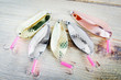 Many fishing lures on wooden surface