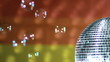 Shiny disco ball spinning with floating bubbles against flag