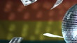 Dollars falling against rainbow flag with spinning disco ball