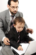 Portrait of a happy young man and his son working on laptop