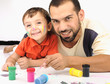 Father and kid playing with paint colors