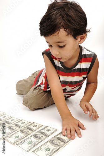Photo: Cute little boy plays with money Cute little boy plays with money