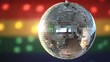 Disco ball spinning against rainbow flag