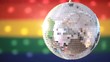Disco ball revolving against gay pride flag