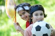 Photo: Young boys with football and tennis outside Young boys with football and tennis outside