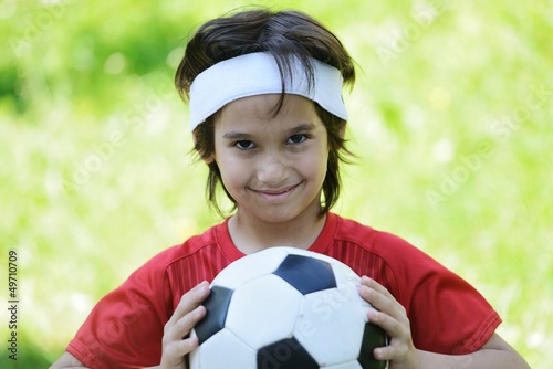 Photo: Young boy with football soccer outside Young boy with football soccer outside