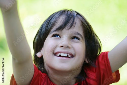 Photo: Closeup portrait of a little happy boy outside Closeup portrait of a little happy boy outside
